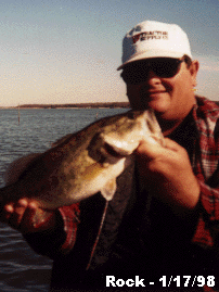 Rock holding a bass